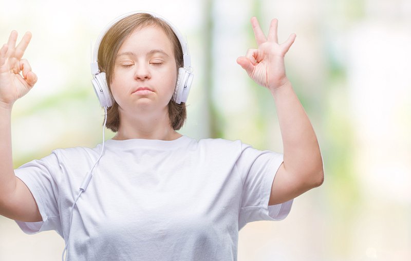 meditating women wearing headphones